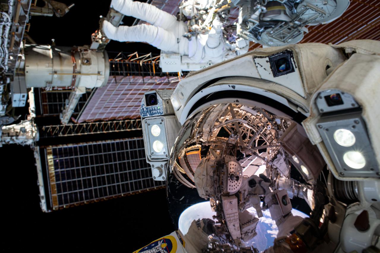 iss065e145237 (June 25, 2021) --- This unique "space-selfie" from spacewalker Thomas Pesquet of ESA (European Space Agency) captures he and NASA spacewalker Shane Kimbrough as they work to complete the installation of the second roll out solar array on the International Space Station's Port-6 truss structure.