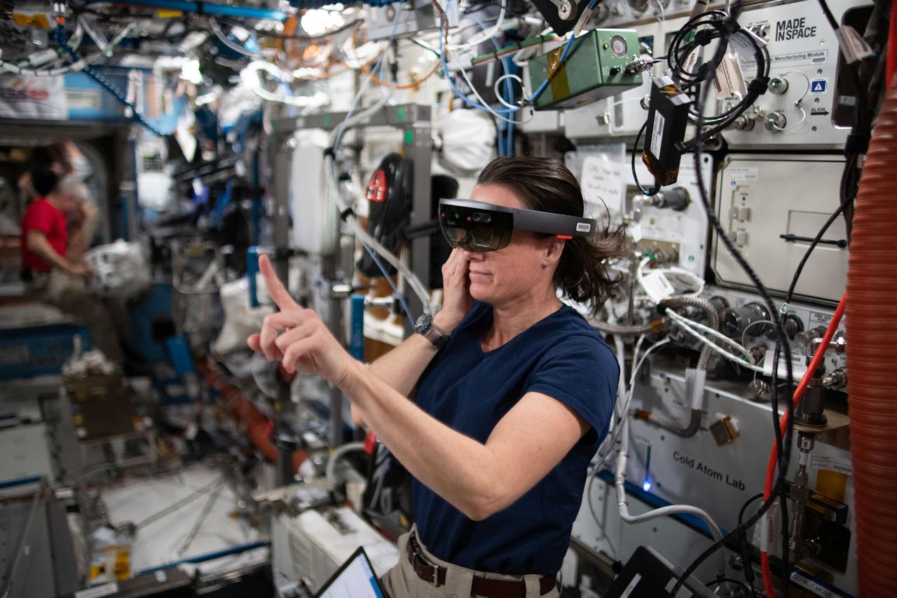 iss065e154542 (June 30, 2021) --- NASA astronaut and Expedition 65 Flight Engineer Megan McArthur wears the specialized Sidekick headset and tests using augmented reality aboard the International Space Station.