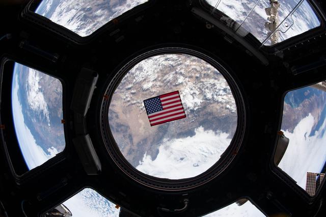 NASA image: U.S. flag in Cupola window