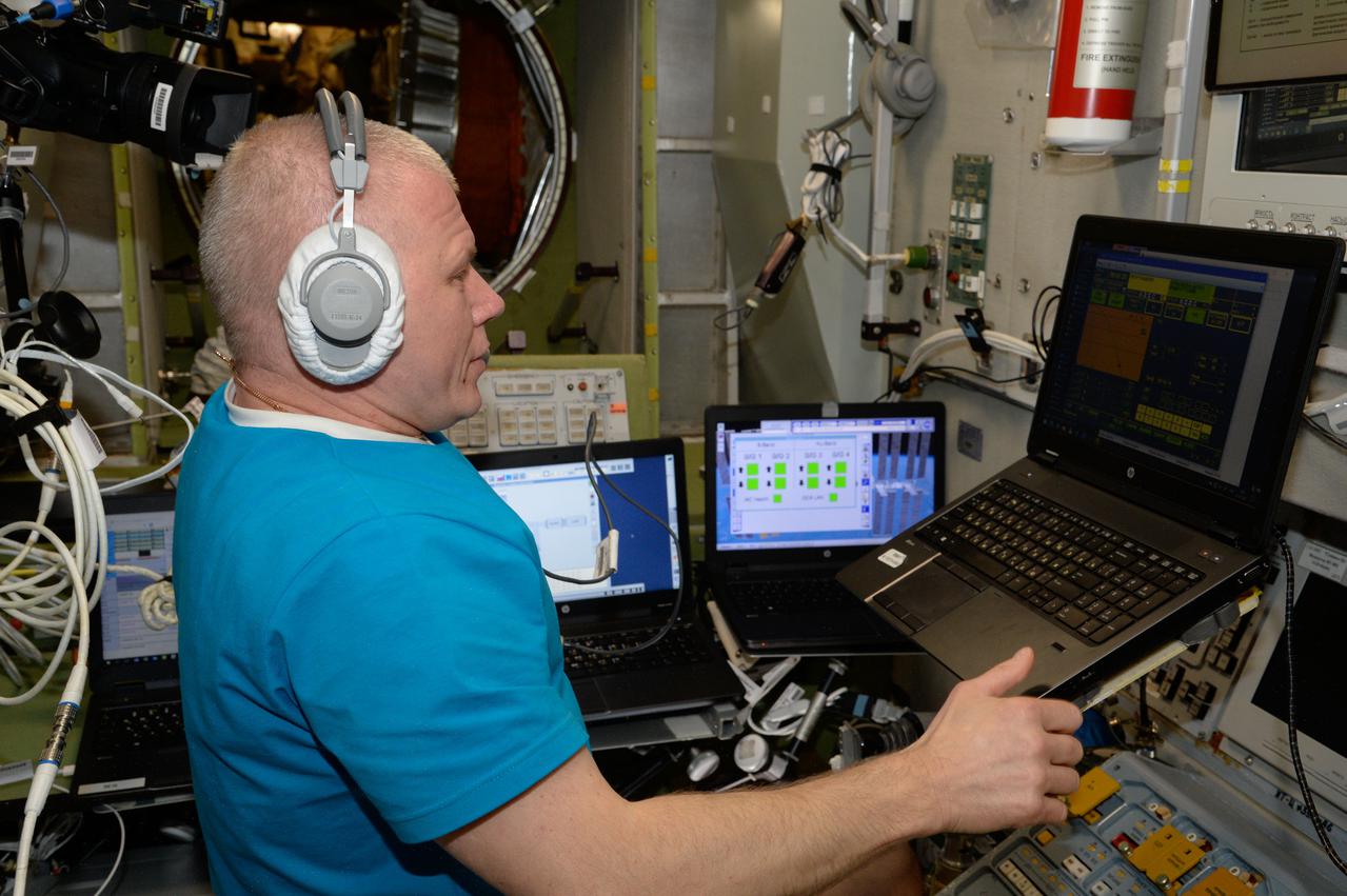 iss065e158152 (July 7, 2021) --- Roscosmos cosmonaut and Expedition 65 Flight Engineer Oleg Novitskiy practices an emergency Soyuz crew ship evacuation drill on a computer during inside the International Space Station's Zvezda service module.