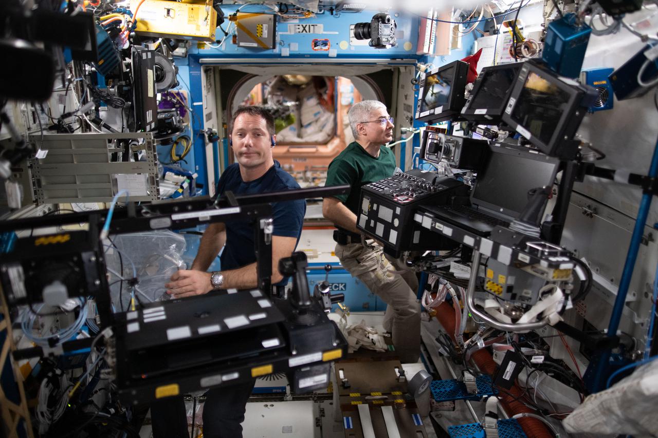 iss065e158339 (July 8, 2021) --- Expedition 65 Flight Engineers (from left) Thomas Pesquet and Mark Vande Hei service a variety of hardware aboard the International Space Station's U.S. Destiny laboratory module.