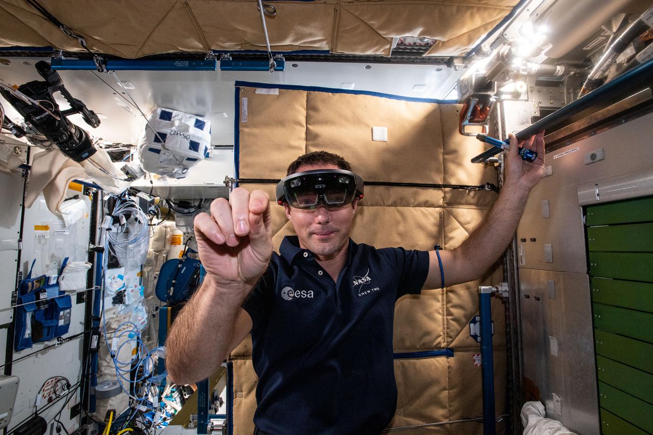 iss065e162496 (July 6, 2021) --- Expedition 65 Flight Engineer Thomas Pesquet of ESA (European Space Agency) wears the Sidekick augmented reality goggles that assist crew members during operations with science experiments and orbital maintenance tasks.