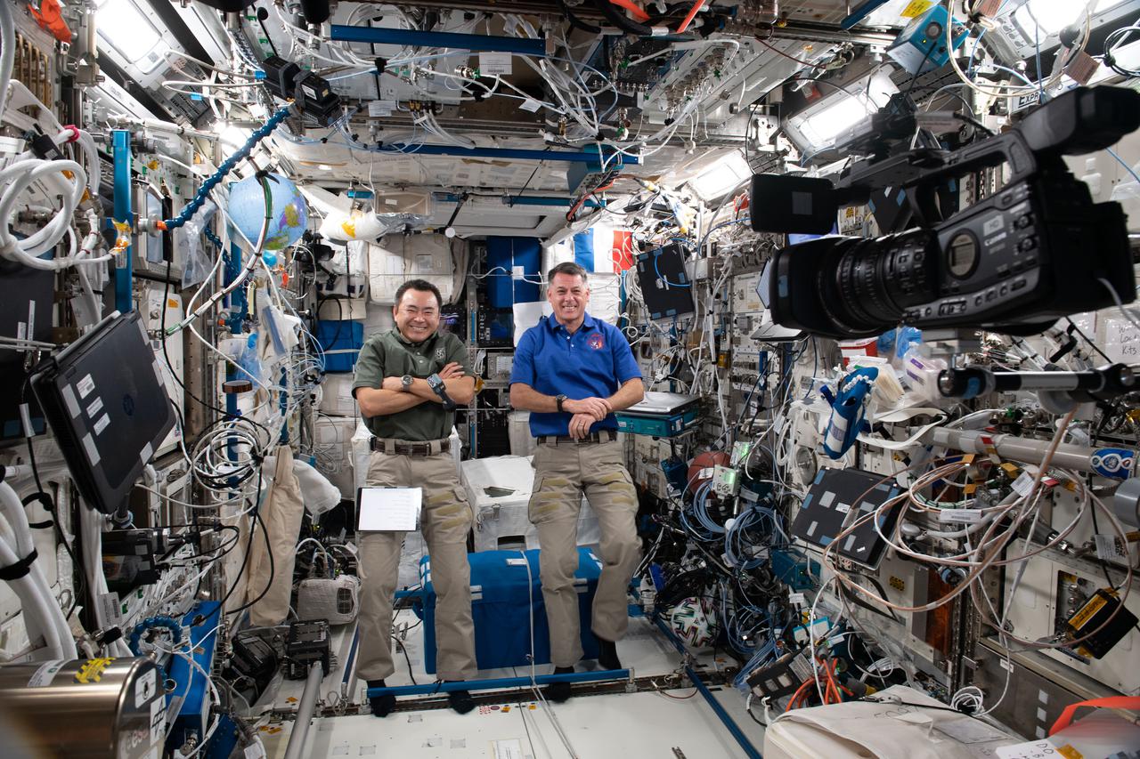 iss065e163241 (June 9, 2021) --- Expedition 65 astronauts (from left) Akihiko Hoshide and Shane Kimbrough talk to elementary school students from New York City during a public affairs event inside the International Space Station's Columbus laboratory module.