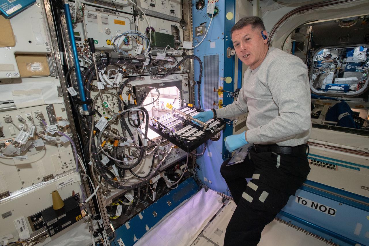 (iss065e163668) July 12, 2021 --- NASA astronaut and Expedition 65 Flight Engineer Shane Kimbrough inserts a device called a science carrier into the Advanced Plant Habitat (APH), which contains 48 Hatch chile pepper seeds NASA started growing on July 12, 2021 as part of the Plant Habitat-04 experiment. Astronauts on station and a team of researchers at Kennedy will work together to monitor the peppers’ growth for about four months before harvesting them. This will be one of the longest and most challenging plant experiments attempted aboard the orbital lab.