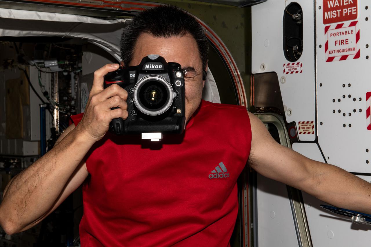 iss065e164333 (June 12, 2021) --- Expedition 65 Commander Akihiko Hoshide of the Japan Aerospace Exploration Agency (JAXA) is pictured during photographic activities aboard the International Space Station.