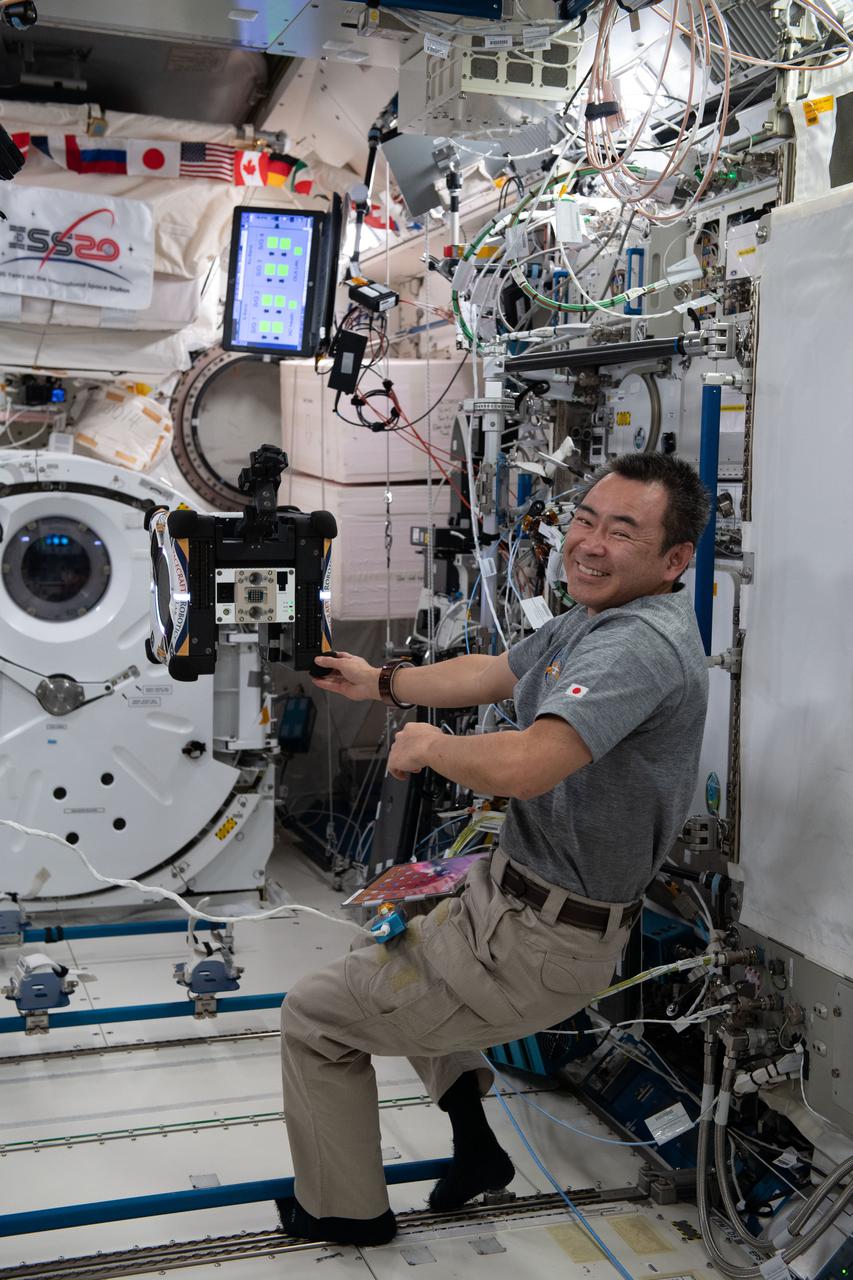 iss065e167830 (July 16, 2021) --- Expedition 65 Commander Akihiko Hoshide of the Japan Aerospace Exploration Agency (JAXA) configures the Astrobee robotic free-flyer to demonstrate complex maneuvers in the orbital lab while using less propulsion. The Astrobatics robotic mobility study has implications for future space missions and technologies on Earth.