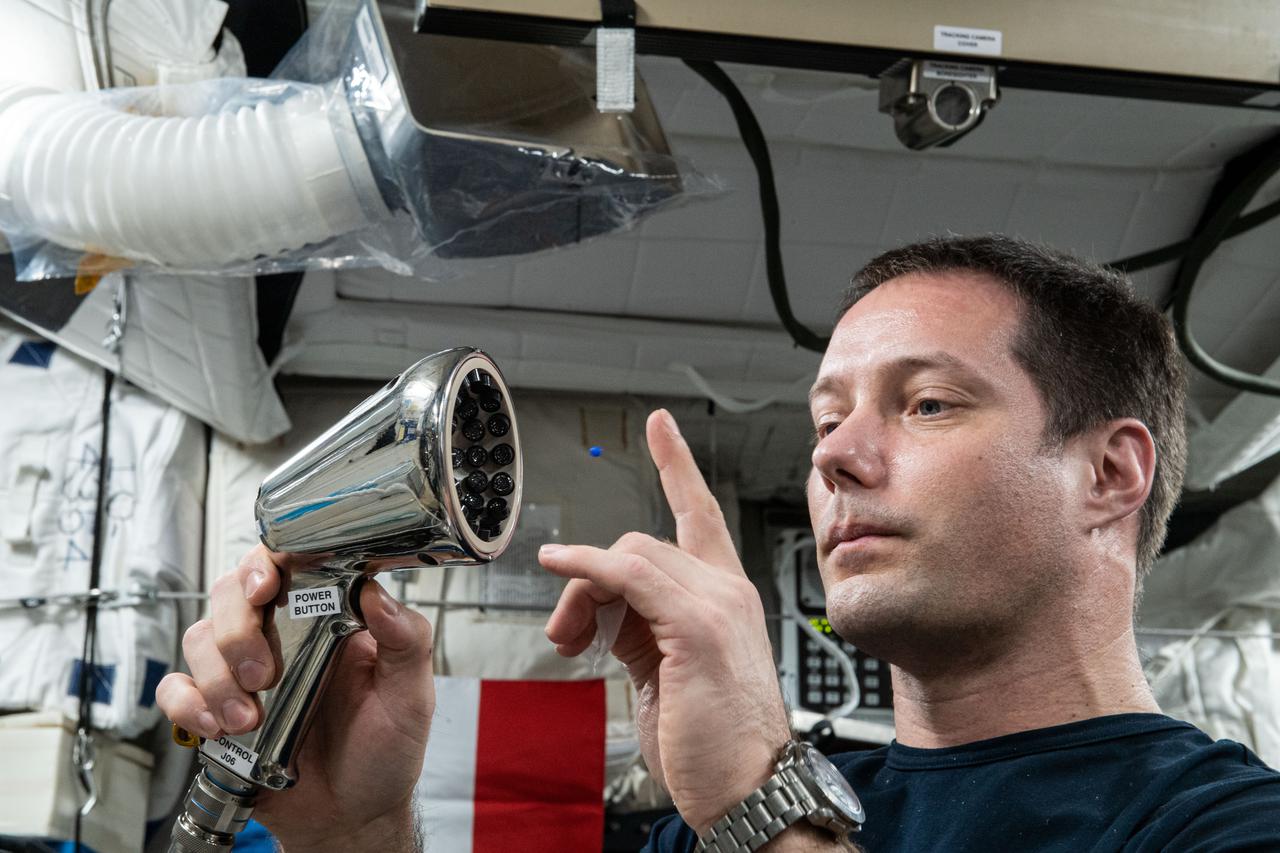 iss065e170099 (7/20/2021) --- European Space Agency (ESA) astronaut Thomas Pesquet working with the Ultrasonic Tweezers experiment setup and execution in the Columbus module aboard the International Space Station (ISS). The objective of the Ultrasonic Tweezers project is to develop acoustic tweezers that use sound to allow for remote and contactless manipulation of materials in a microgravity context. An ultrasound beam is shaped so that it produces a trap from which an object cannot easily exit. By moving the beam, the object can be moved to a new position with a very good precision.