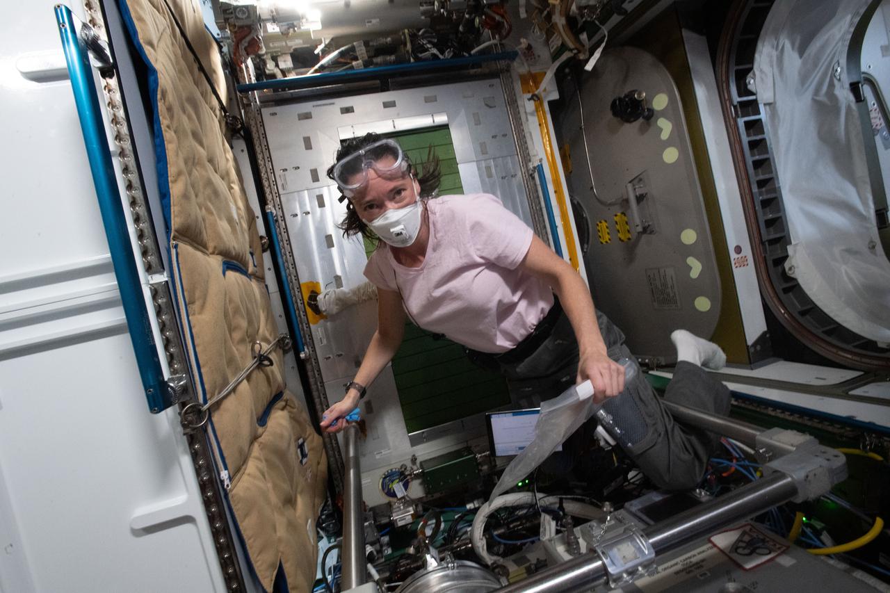 iss065e209025 (June 26, 2021) --- NASA astronaut and Expedition 65 Flight Engineer Megan McArthur reconfigures fluid connections inside the Tranquility module's Waste and Hygiene Compartment aboard the International Space Station.