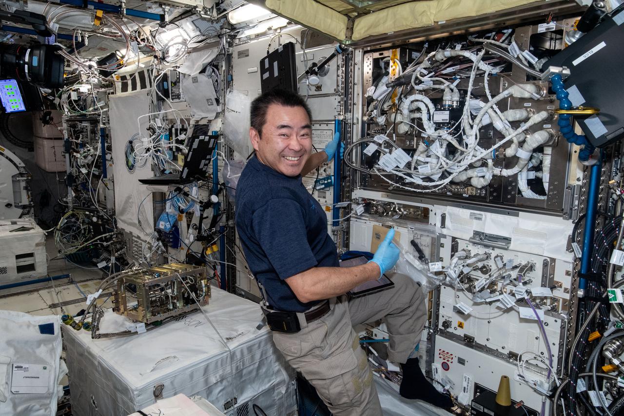 iss065e212128 (July 28, 2021) --- Expedition 65 Commander Akihiko Hoshide of the Japan Aerospace Exploration Agency (JAXA) changes out a sample holder in the Electrostatic Levitation Furnace (ELF) located inside JAXA's Kibo laboratory module. The ELF can heat samples above 2000 degrees Celsius, using a semiconductor laser from four different directions, and can also measure the thermophysical properties (density, surface tension, and viscosity) of high temperature materials, which are very difficult to measure on the Earth.