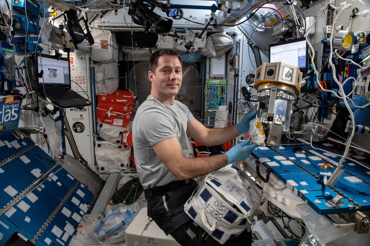 iss065e216071 (Aug. 10, 2021) --- Expedition 65 Flight Engineer Thomas Pesquet of ESA (European Space Agency) sets up a cinematic virtual reality (VR) camera to film station activities. The immersive ISS Experience VR series documents a variety of crew activities aboard the International Space Station for audiences on Earth.