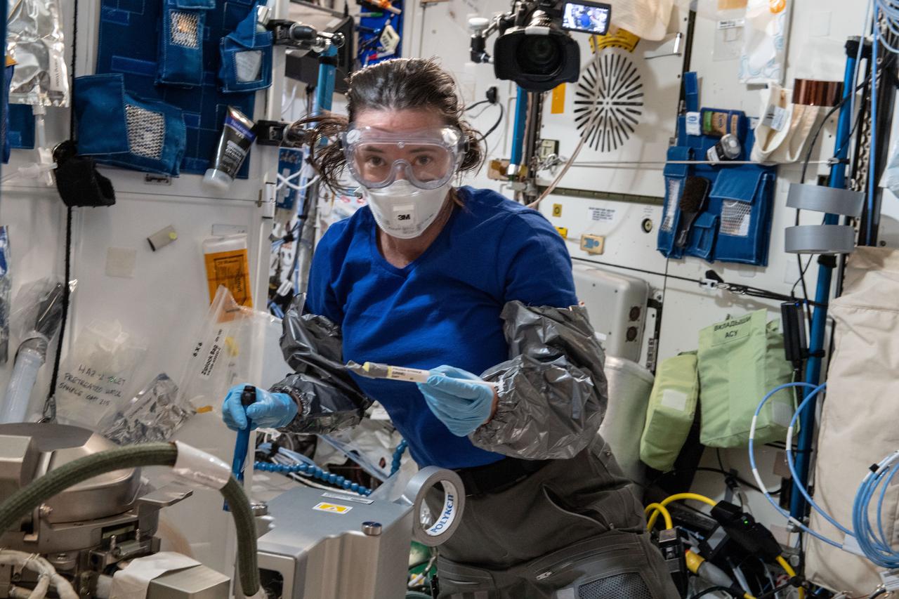 iss065e216084 (Aug. 3, 2021) --- NASA astronaut and Expedition 65 Flight Engineer Megan McArthur works on orbital plumbing tasks inside the Tranquility module on the Waste and Hygiene and Compartment, or the International Space Station's bathroom.