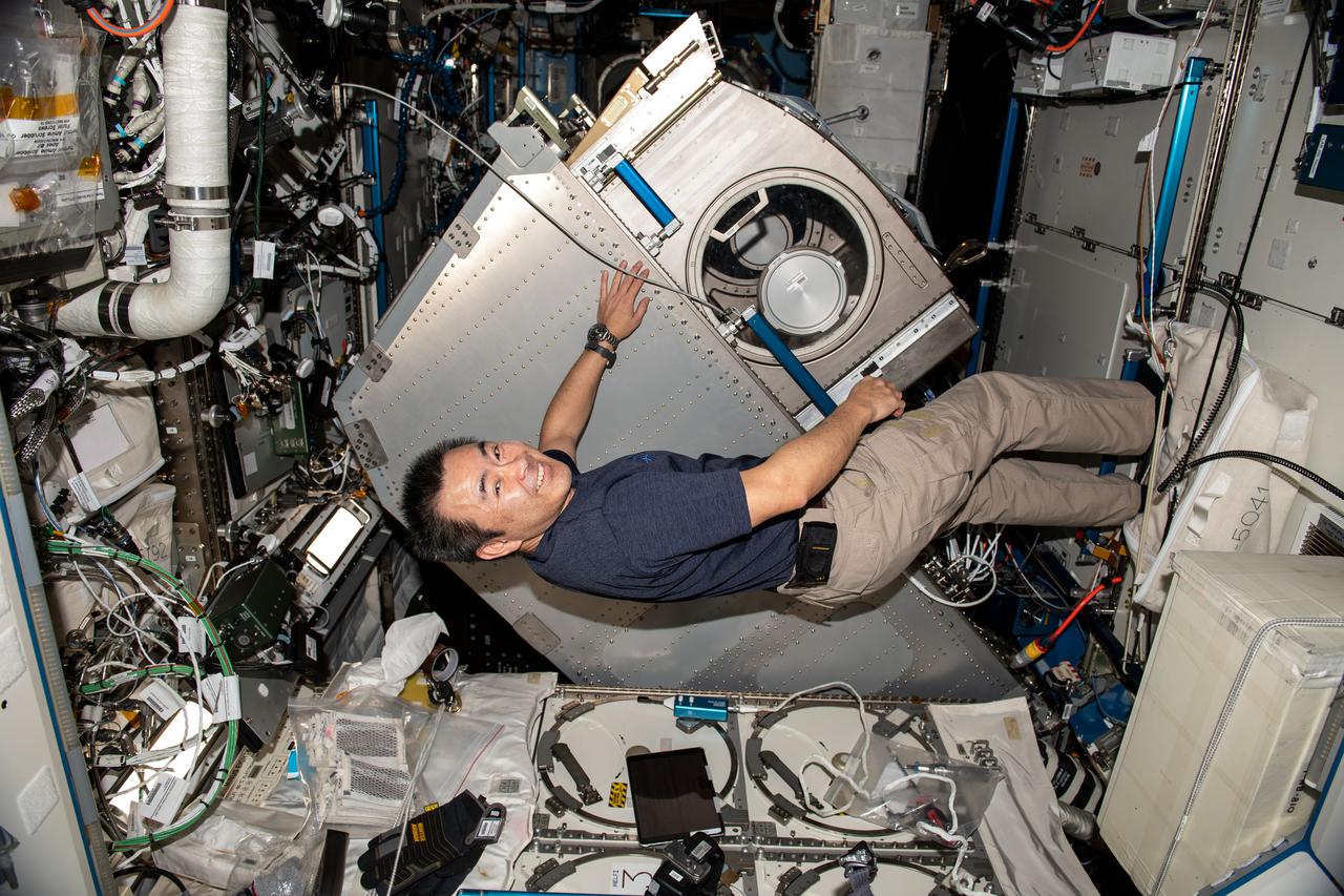 iss065e241905 (Aug. 11, 2021) --- Expedition 65 Commander Akihiko Hoshide of the Japan Aerospace Exploration Agency (JAXA) rotates the Microgravity Science Glovebox (MSG) from its rack position inside the International Space Station's U.S. Destiny laboratory module. Hoshide cleaned electronic components inside the MSG following completion of the InSpace-4 physics experiment that studied the assembly of tiny structures from colloids using magnetic fields.