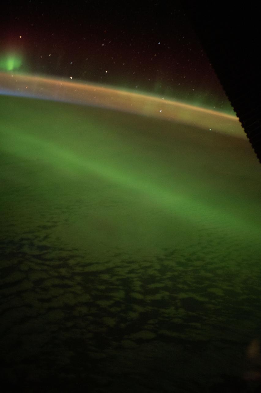 iss065e243361 (Aug. 8, 2021) --- The aurora australis streams above the Earth's atmosphere and below the International Space Station as it orbited 271 miles over the southern Indian Ocean.