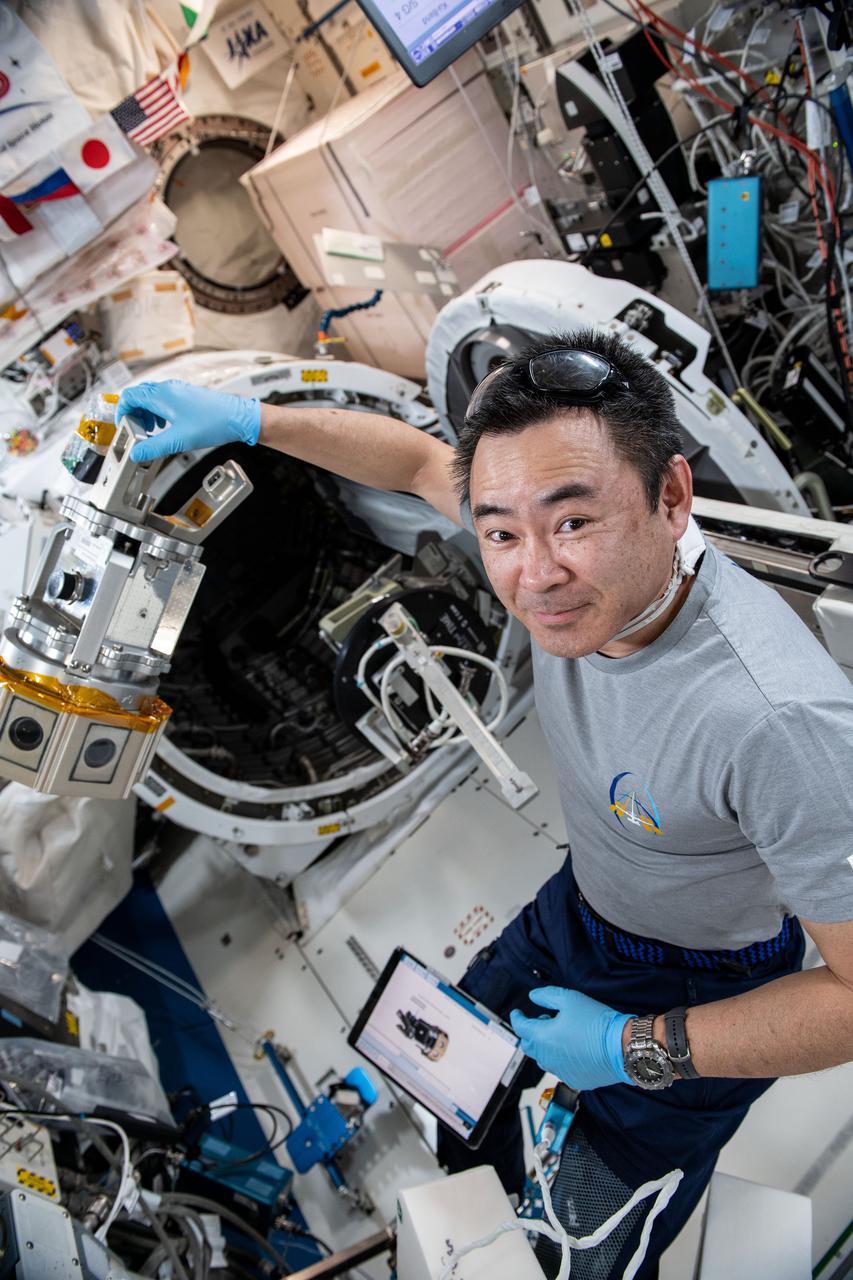 iss065e248599 (Aug. 16, 2021) --- Expedition 65 Commander Akihiko Hoshide of the Japan Aerospace Exploration Agency (JAXA) works in the Kibo laboratory module setting up a cinematic virtual reality (VR) camera to film station activities. The immersive ISS Experience VR series documents a variety of crew activities aboard the International Space Station for audiences on Earth.