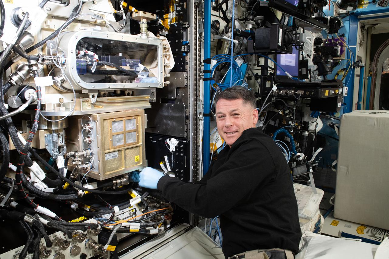 iss065e257486 (Aug. 17, 2021) --- NASA astronaut and Expedition 65 Flight Engineer Shane Kimbrough installs and configures a new Advanced Colloids Experiment module inside the U.S. Destiny laboratory module's Fluids Integrated Rack (FIR). The work supports the ACE-T9 fluid physics study that uses the FIR's Light Microscopy Module to image colloidal molecules for insights into the development of advanced materials not possible to produce in Earth's gravity.