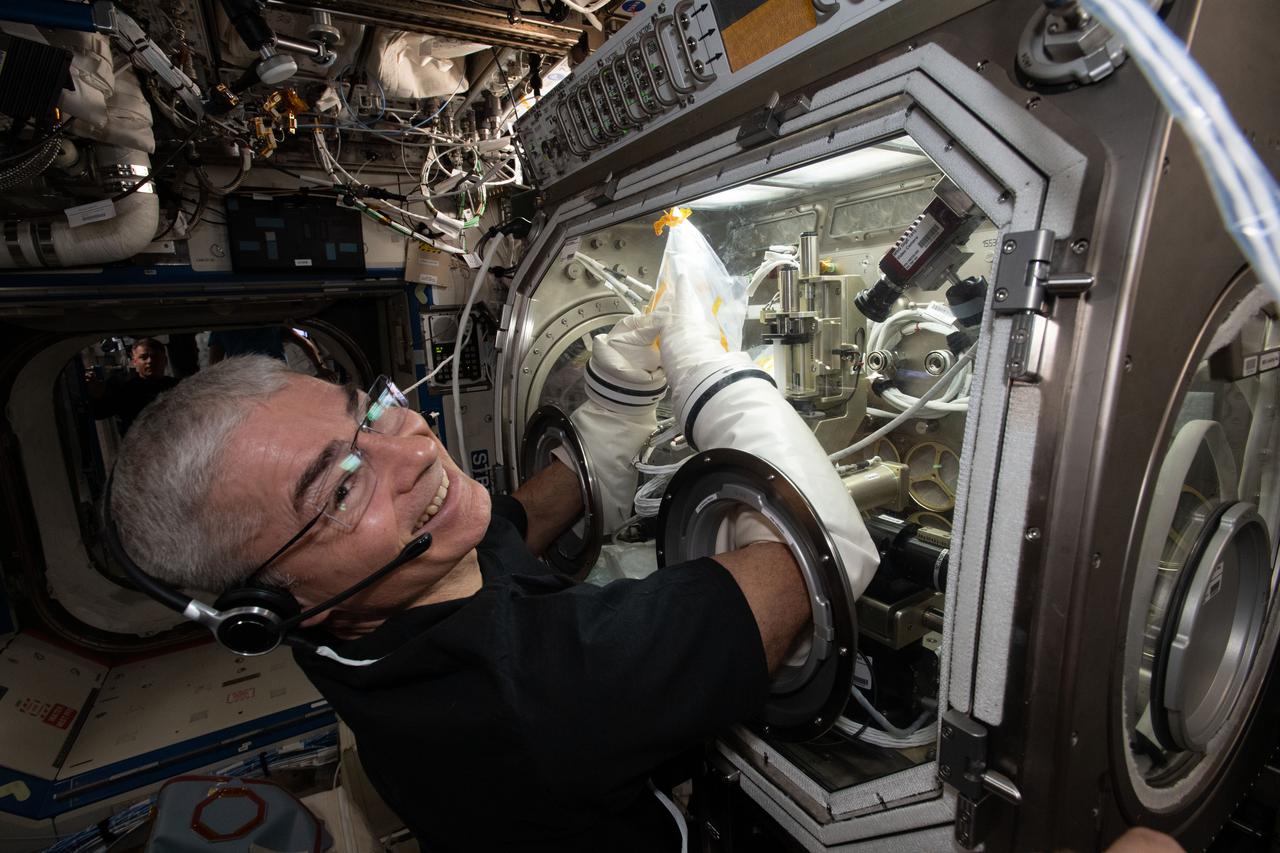 iss065e276849 (Aug. 16, 2021) --- NASA astronaut and Expedition 65 Flight Engineer Mark Vande Hei works inside the U.S. Destiny laboratory module's Microgravity Science Glovebox for the Ring Sheared Drop fluid physics study.