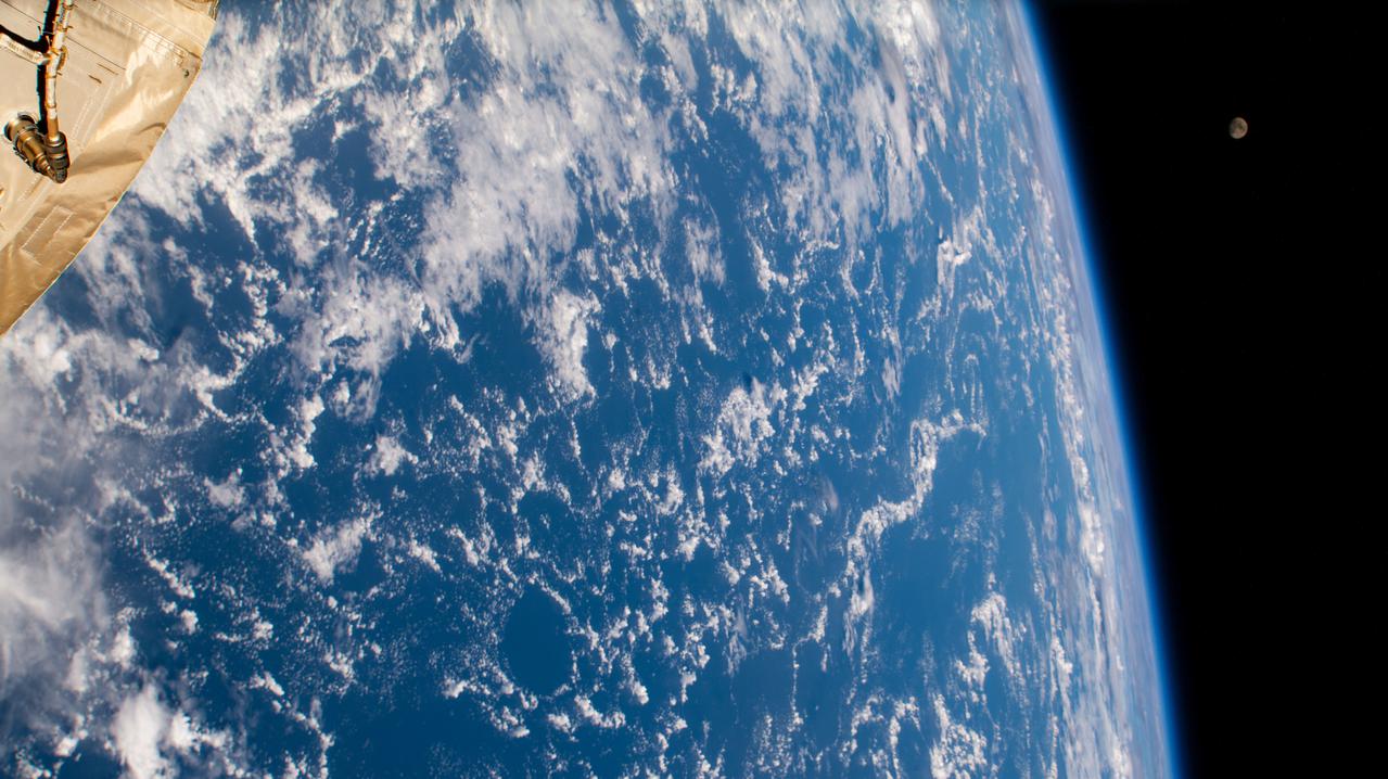 iss065e280824 (Aug. 19, 2021) --- The waxing gibbous Moon (upper right) is pictured from the International Space Station as it orbited 262 miles above the Atlantic Ocean just east of the Lesser Antilles, a group of islands in the Caribbean Sea.