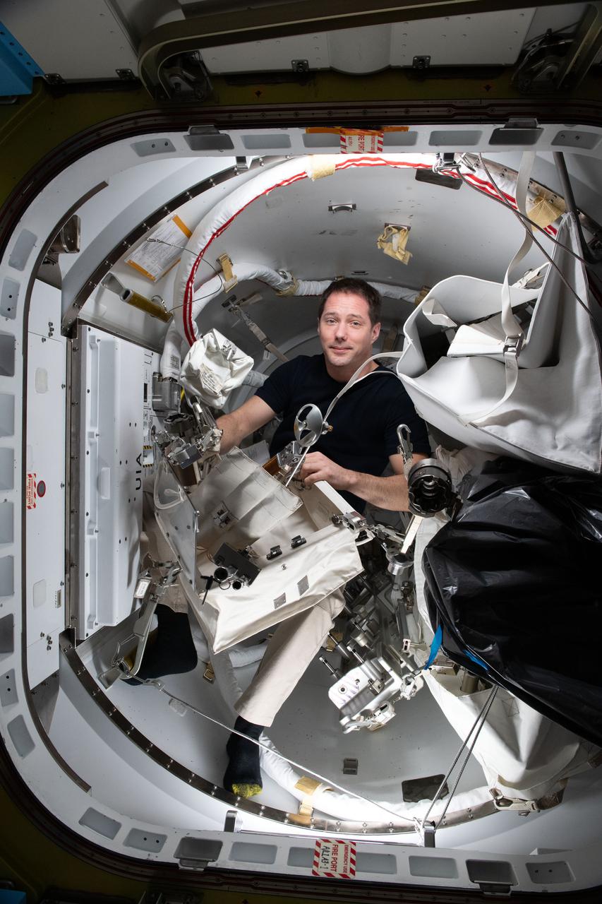 iss065e290307 (Aug. 23, 2021) --- Flight Engineer Thomas Pesquet of ESA (European Space Agency) checks a variety of spacewalk tools inside the International Space Station's U.S. Quest airlock.