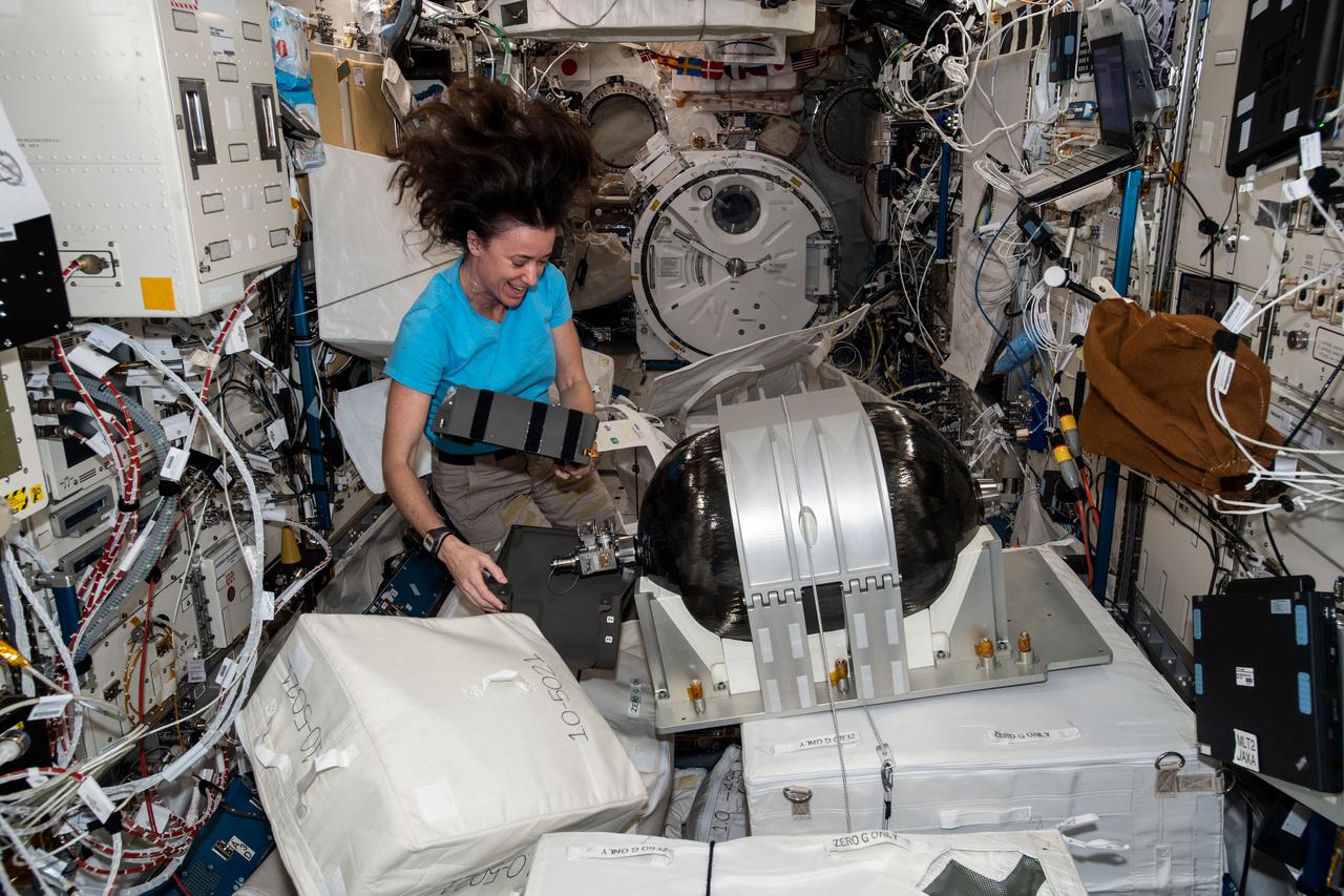 iss065e291100 (Aug. 24, 2021) --- NASA astronaut and Expedition 65 Flight Engineer Megan McArthur assembles an Emergency Air Supply (EAS) tank inside the International Space Station's Kibo laboratory module.