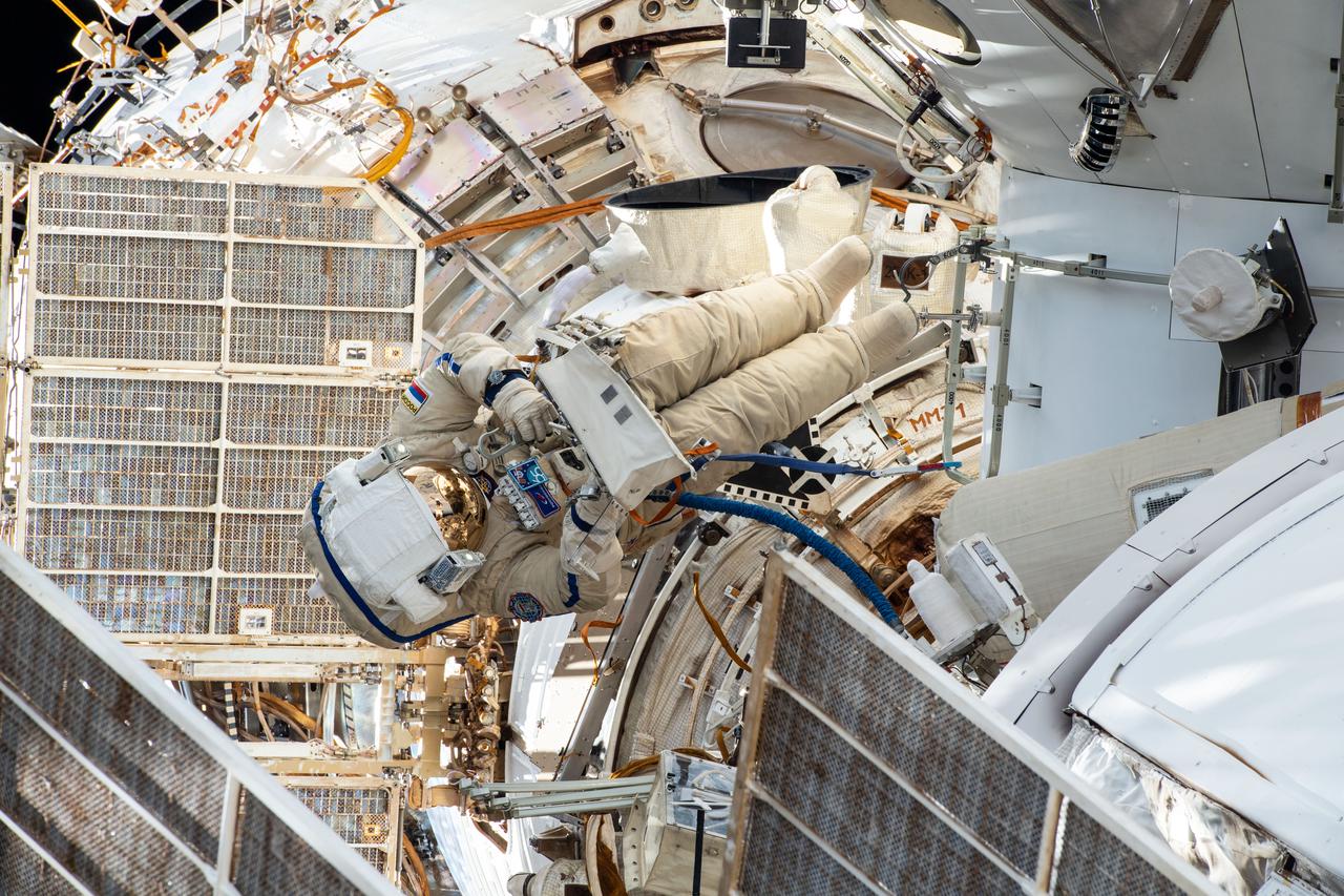 iss065e349034 (Sept. 3, 2021) --- Expedition 65 Flight Engineer Pyotr Dubrov from Roscosmos is pictured during a spacewalk to begin outfitting Russia's Nauka multipurpose laboratory module with ethernet cables, power cables and handrails.