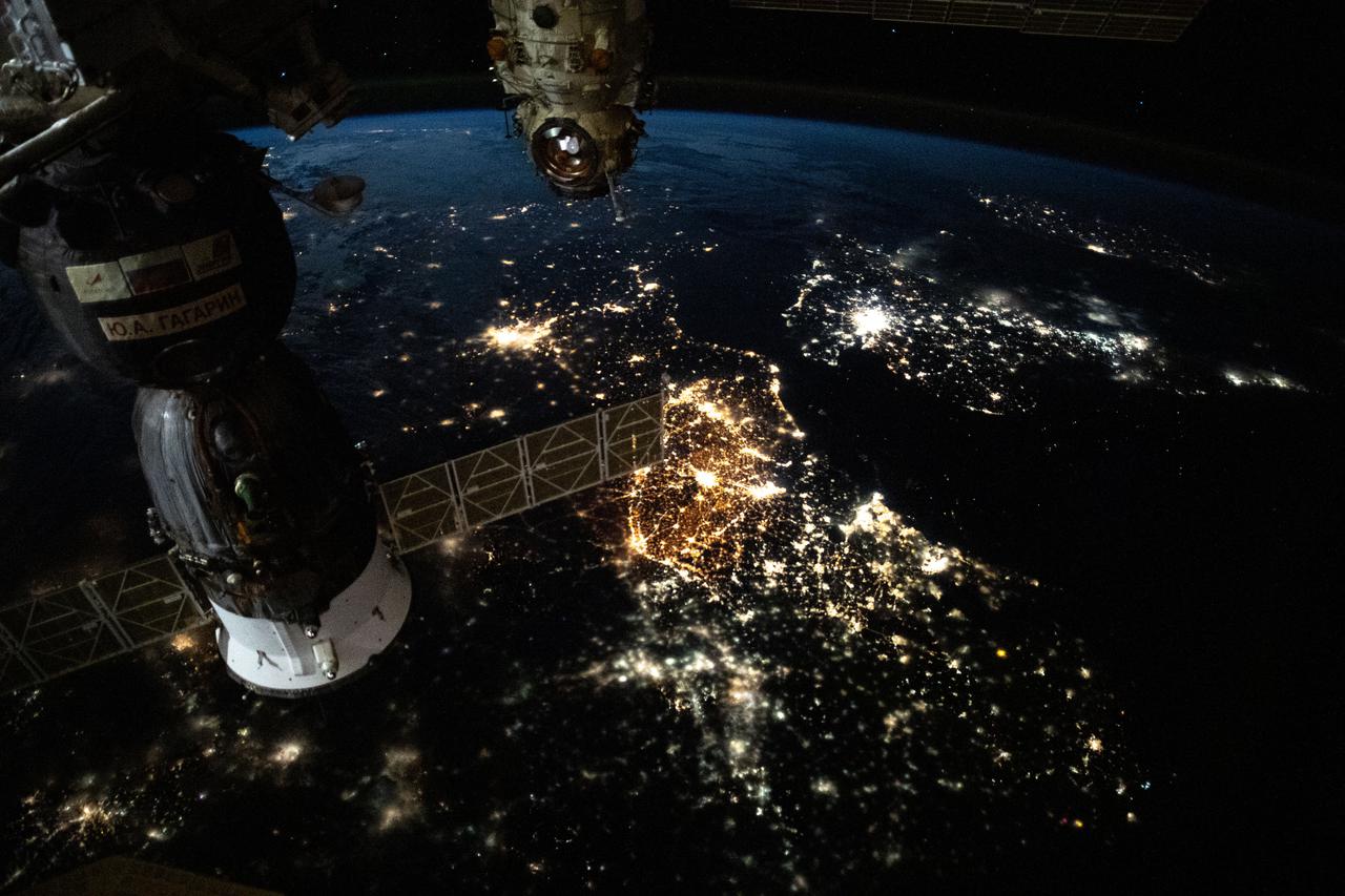 iss065e385473 (Sept. 15, 2021) --- The prominent city lights of Europe from Amsterdam to Paris and London across the English Channel are pictured as the International Space Station orbited 265 miles above the continent. The Soyuz MS-18 crew ship (left) and a portion of the Nauka multipurpose laboratory module (right) are pictured docked to the station's Russian segment