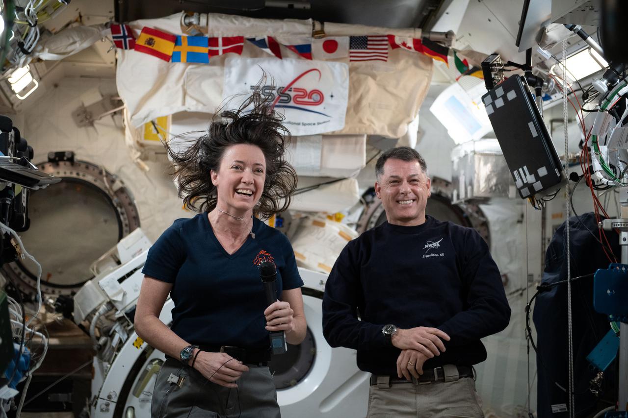 iss065e385768 (Sept. 17, 2021) --- NASA's Expedition 65 Flight Engineers Megan McArthur and Shane Kimbrough are pictured inside the Kibo laboratory module answering questions from U.S. journalists on Earth.