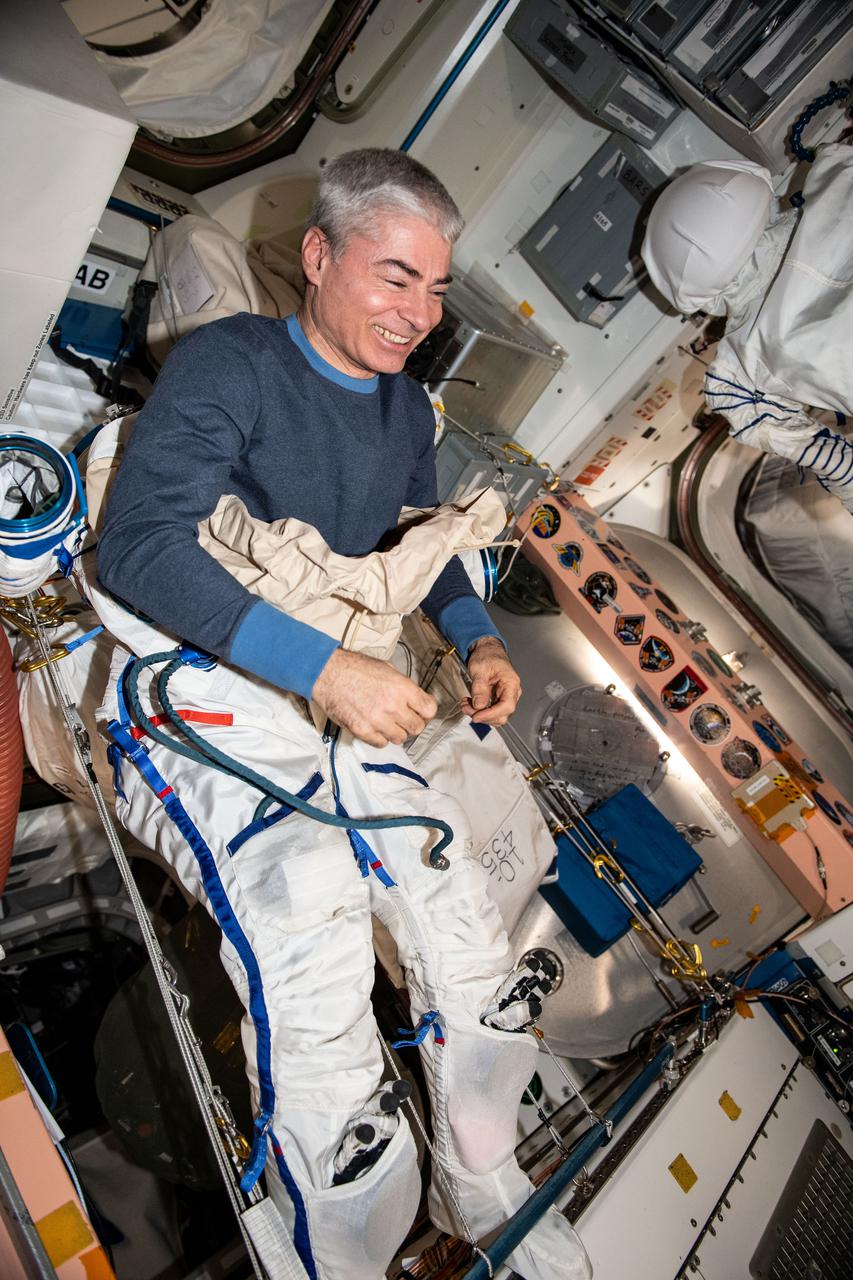 iss065e398685 (Sept. 21, 2021) --- NASA astronaut and Expedition 65 Flight Engineer Mark Vande Hei tries on the Sokol launch and entry suit he will wear inside the Soyuz MS-18 crew ship when it undocks from the Rassvet module and redocks to the Nauka multipurpose module.