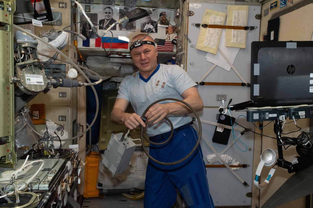 iss065e411233 (Sept. 22, 2021) --- Roscosmos cosmonaut and Expedition 65 Flight Engineer Oleg Novitskiy is pictured servicing Russian life support components inside the International Space Station's Zvezda service module.