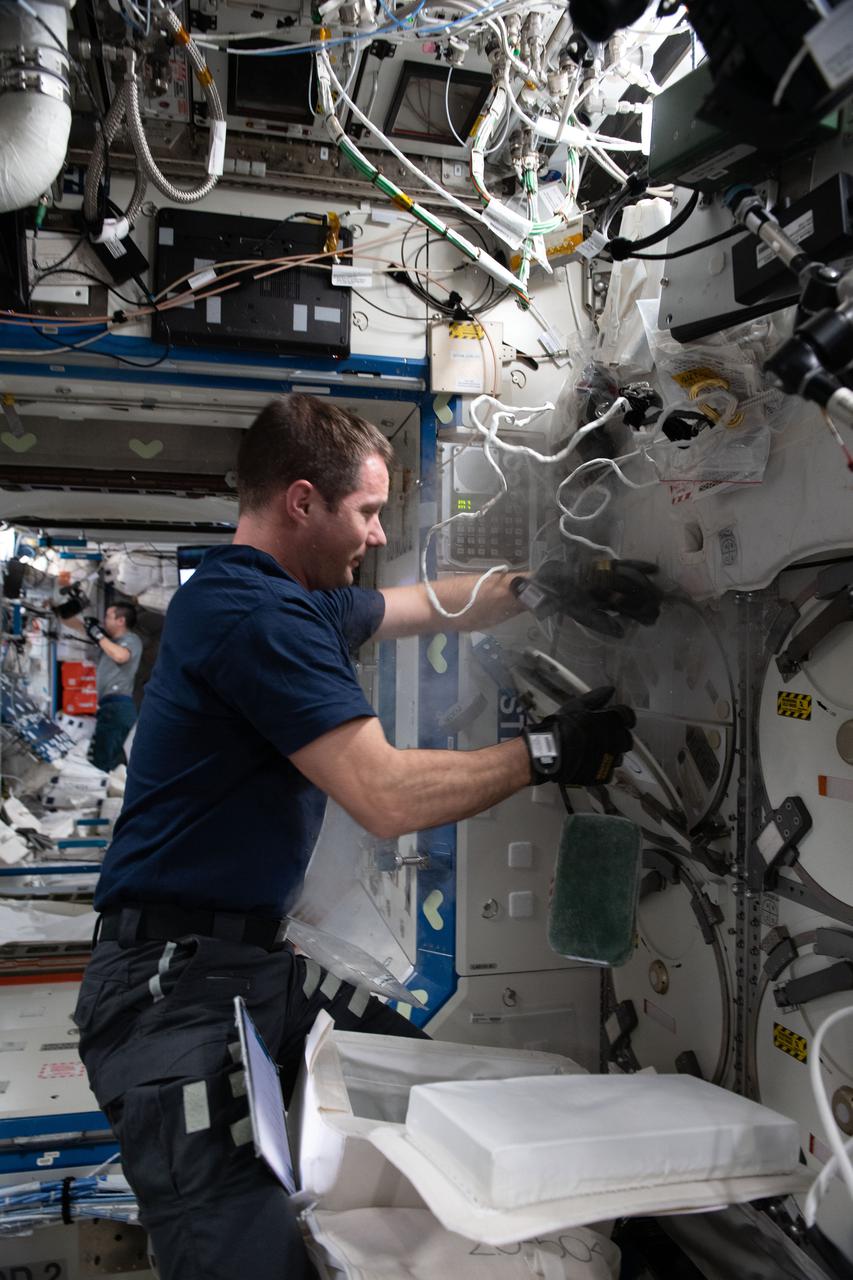 iss065e431756 (Oct. 2, 2021) --- Expedition 65 Commander Thomas Pesquet of ESA (European Space Agency) collects research samples preserved in science freezers aboard the International Space Station in preparation for stowage inside the SpaceX Cargo Dragon resupply ship for return and analysis on Earth.