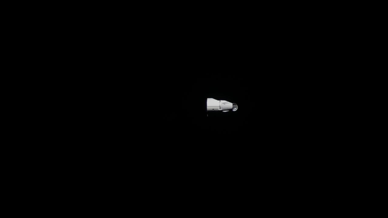 iss065e434115 (Sept. 30, 2021) --- The SpaceX Cargo Dragon, with its nose cone open, is pictured from an external high definition camera departing the vicinity of the International Space Station.