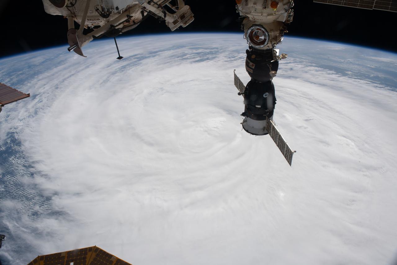 iss065e434707 (Oct. 1, 2021) --- The International Space Station orbits 261 miles above Typhoon Mindulle just off the Pacific coast of Japan. The Soyuz MS-18 spacecraft is pictured docked to Russia’s Nauka multipurpose laboratory module.
