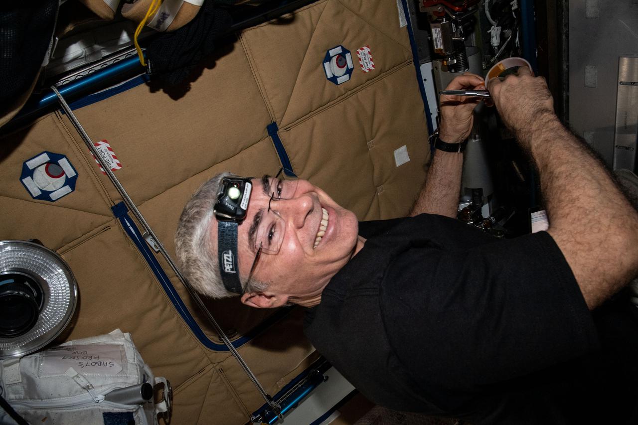 iss065e440489 (Oct. 4, 2021) --- NASA astronaut and Expedition 65 Flight Engineer Mark Vande Hei smiles for the camera while working on maintenance activities inside the International Space Station's Tranquility module.