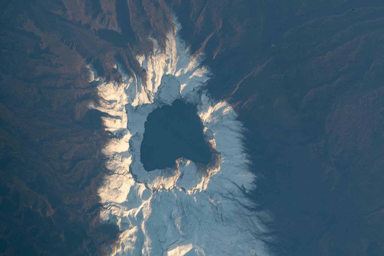 iss065e444007 (Oct. 8, 2021) --- Heaven Lake rests in the crater of the active volcano Paektu Mountain that lies on the China-North Korea border. The International Space Station was orbiting 263 miles above Asia at the time this photograph was taken.