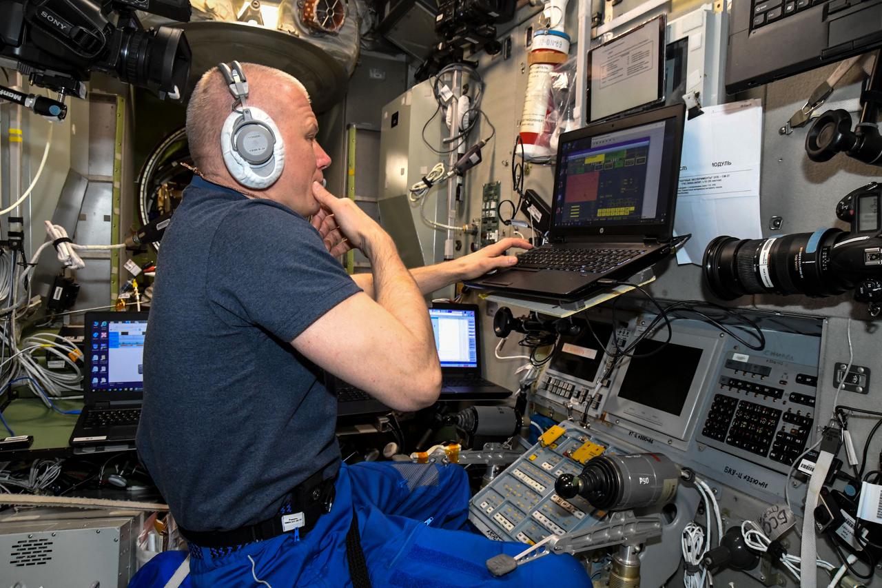 iss065e44314 (Oct. 8, 2021) --- Roscosmos cosmonaut and Expedition 65 Flight Engineer Oleg Novitskiy is inside the Zvezda service module training on a computer for the maneuvers he will use when undocking from the International Space Station and returning to Earth inside the Soyuz MS-18 crew ship. He will transit with spaceflight participants Yulia Peresild and Klim Shipenko just after midnight Eastern time on Oct. 17.