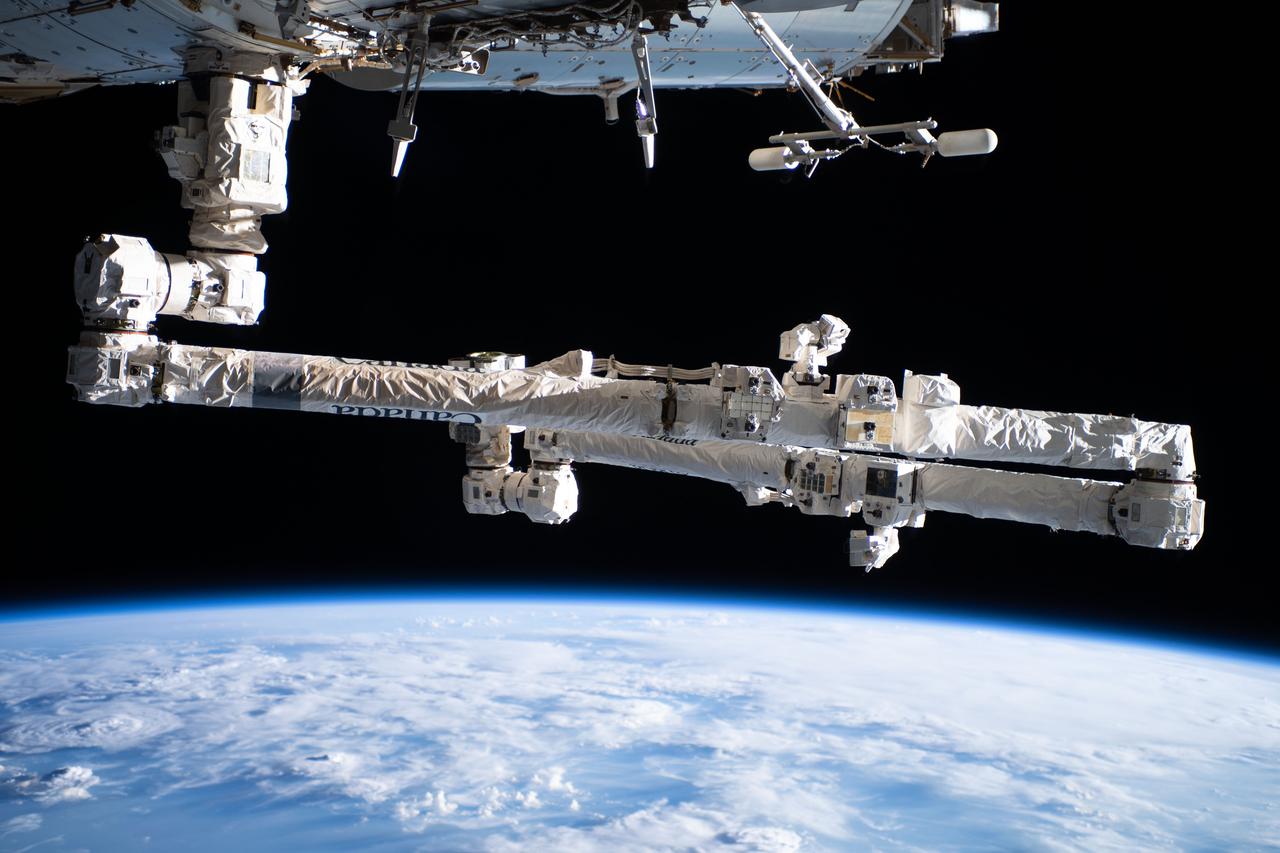 iss065e483088 (Oct. 15. 2021) --- The Canadarm2 robotic arm, in a folded configuration, is pictured attached to the International Space Station as it orbited 263 miles above the Atlantic Ocean off the coast of Brazil.