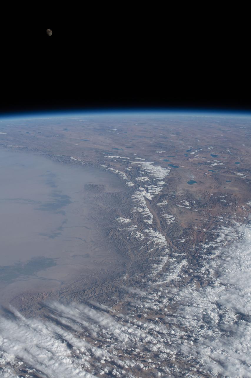 iss065e484869 (Oct. 16. 2021) --- The waxing gibbous Moon is pictured over Earth's horizon as the International Space Station orbited 262 miles above Tajikistan.
