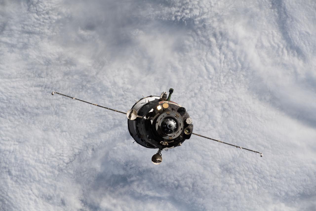 iss066e001123 (Oct. 17, 2021) --- The Soyuz MS-18 crew ship, carrying Soyuz Commander Oleg Novitskiy and spaceflight participants Yulia Peresild and Klim Shipenko, is pictured departing the vicinity of the International Space Station as both spacecraft were orbiting 263 miles above the Sea of Okhotsk.