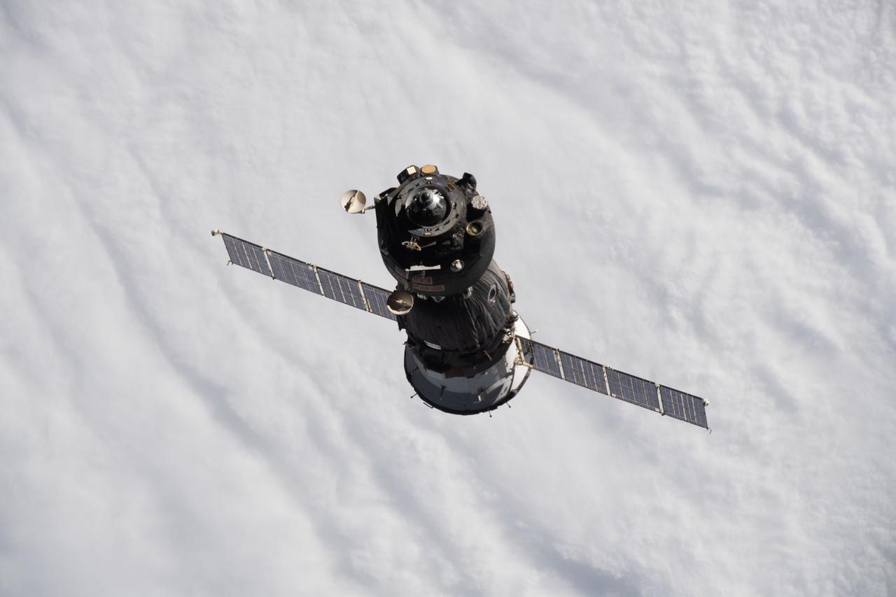 iss066e001124 (Oct. 17, 2021) --- The Soyuz MS-18 crew ship, carrying Soyuz Commander Oleg Novitskiy and spaceflight participants Yulia Peresild and Klim Shipenko, is pictured departing the vicinity of the International Space Station as both spacecraft were orbiting 263 miles above the Sea of Okhotsk.