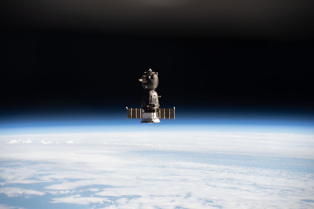 iss066e001176 (Oct. 17, 2021) --- The Soyuz MS-18 crew ship, carrying Soyuz Commander Oleg Novitskiy and spaceflight participants Yulia Peresild and Klim Shipenko, is pictured departing the vicinity of the International Space Station as both spacecraft were orbiting 263 miles above the Pacific Ocean off the coast of far eastern Russia.
