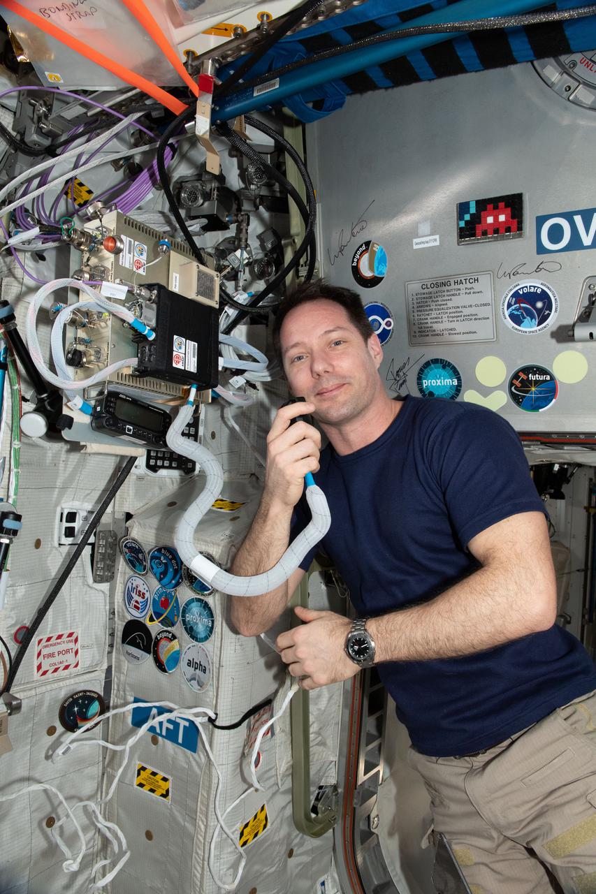 iss066e031742 (November 3, 2021) -- ESA (European Space Agency) astronaut and Expedition 65 Flight Engineer Thomas Pesquet is seen using the Amateur Radio on the International Space Station (ARISS).