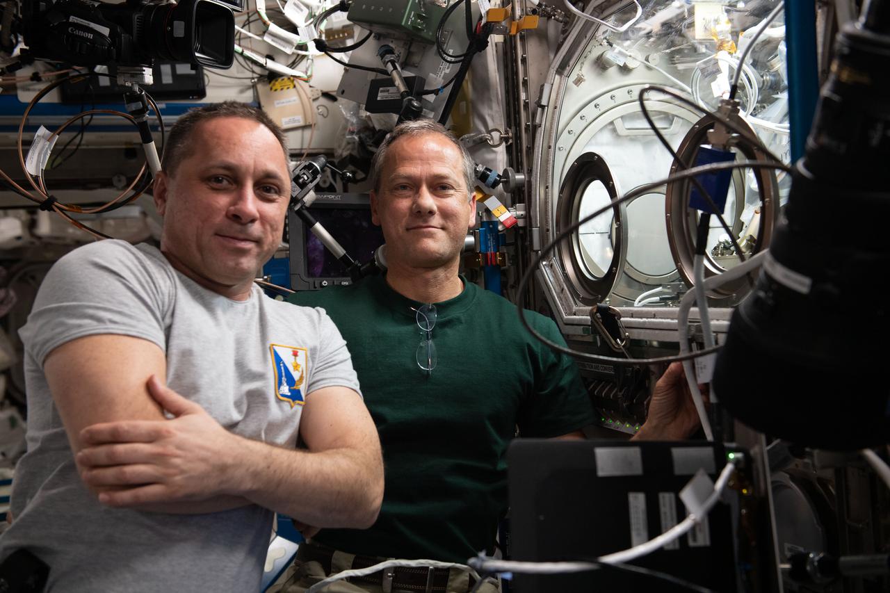 iss066e078285 (Nov. 17, 2021) --- International Space Station Commander Anton Shkaplerov of Roscosmos (from left) and NASA astronaut and Expedition 66 Flight Engineer Thomas Marshburn work on the SUBSA-BRAINS (BRazing of Aluminum alloys IN Space) space physics experiment taking place inside the Microgravity Science Glovebox. The study examines differences in capillary flow, interface reactions, and bubble formation during solidification of brazing alloys in microgravity.