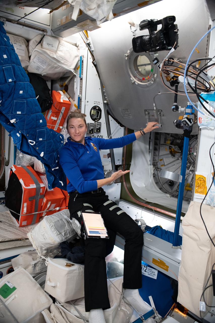 iss066e078289 (Nov. 17, 2021) --- NASA astronaut and Expedition 66 Flight Engineer Kayla Barron opens the hatch to the Columbus laboratory module aboard the International Space Station.