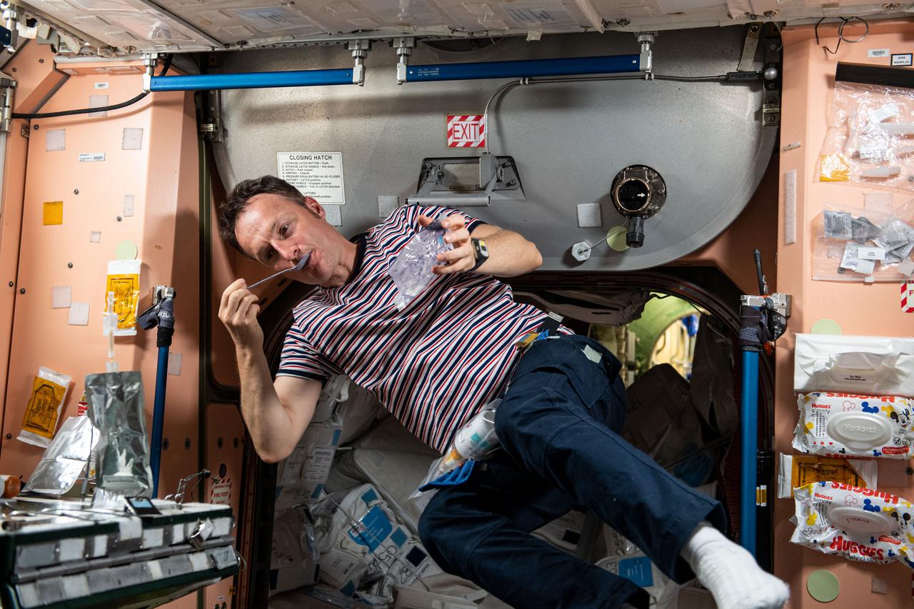 iss066e078572 (Nov. 18, 2021) --- ESA (European Space Agency) astronaut and Expedition 66 Flight Engineer Matthias Maurer is pictured during the breakfast period aboard the International Space Station.
