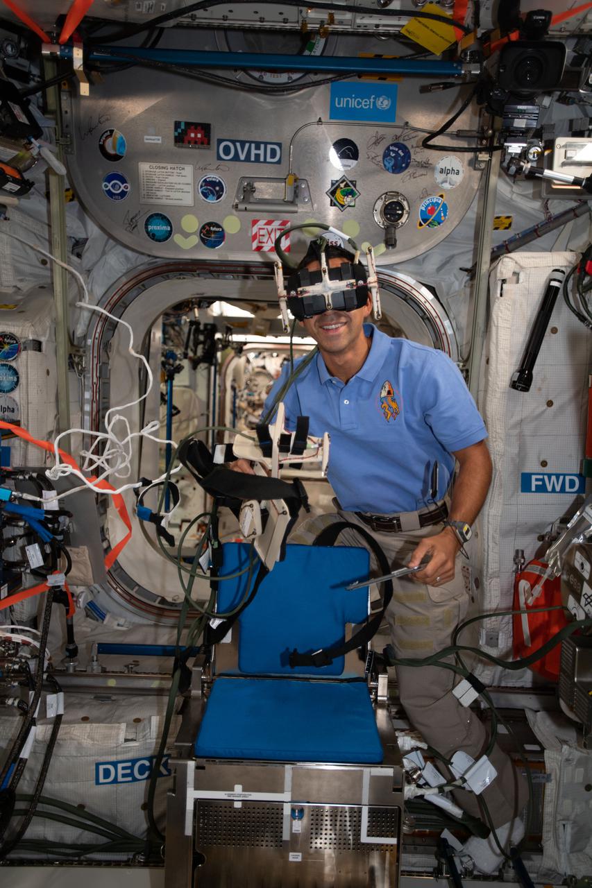 iss066e079006 (Nov. 22, 2021) --- NASA astronaut and Expedition 66 Flight Engineer Raja Chari wears virtual reality goggles inside the International Space Station's Columbus laboratory module. Chari was participating in the GRASP human research experiment that tests how astronauts perceive up and down movements and grip and manipulate objects in microgravity.