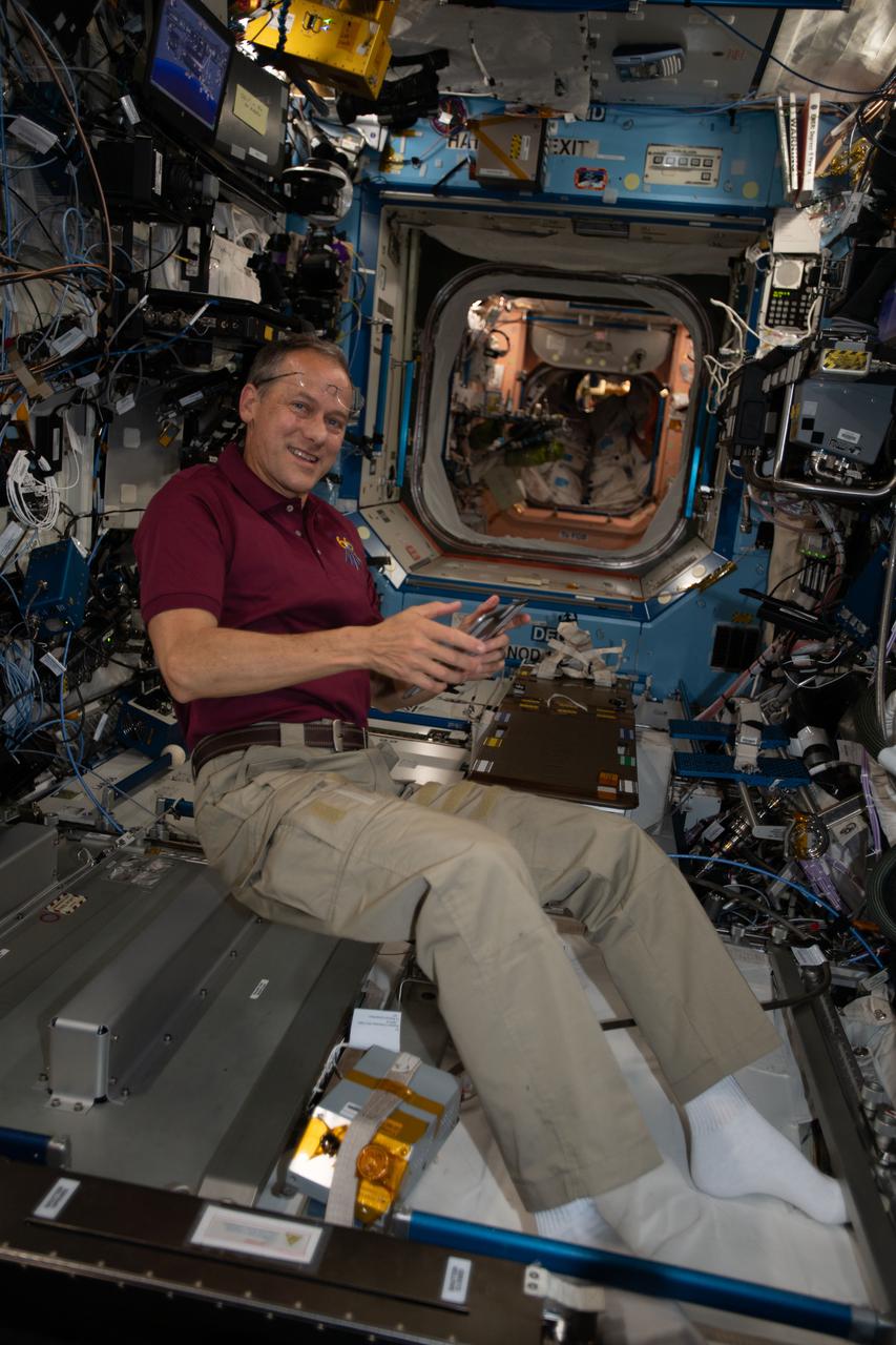 iss066e079009 (Nov. 22, 2021) --- NASA astronaut and Expedition 66 Flight Engineer Thomas Marshburn collects potable water samples from inside the International Space Station's U.S. Destiny laboratory module for later analysis.