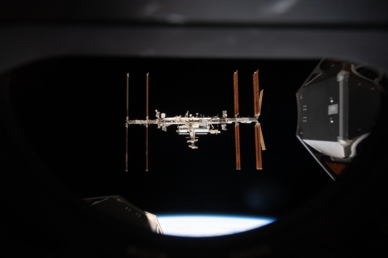 iss066e080907 (Nov. 8, 2021) --- The International Space Station is pictured from inside a window aboard the SpaceX Crew Dragon Endeavour during a fly around of the orbiting lab that took place following its undocking from the Harmony module’s space-facing port on Nov. 8, 2021.
