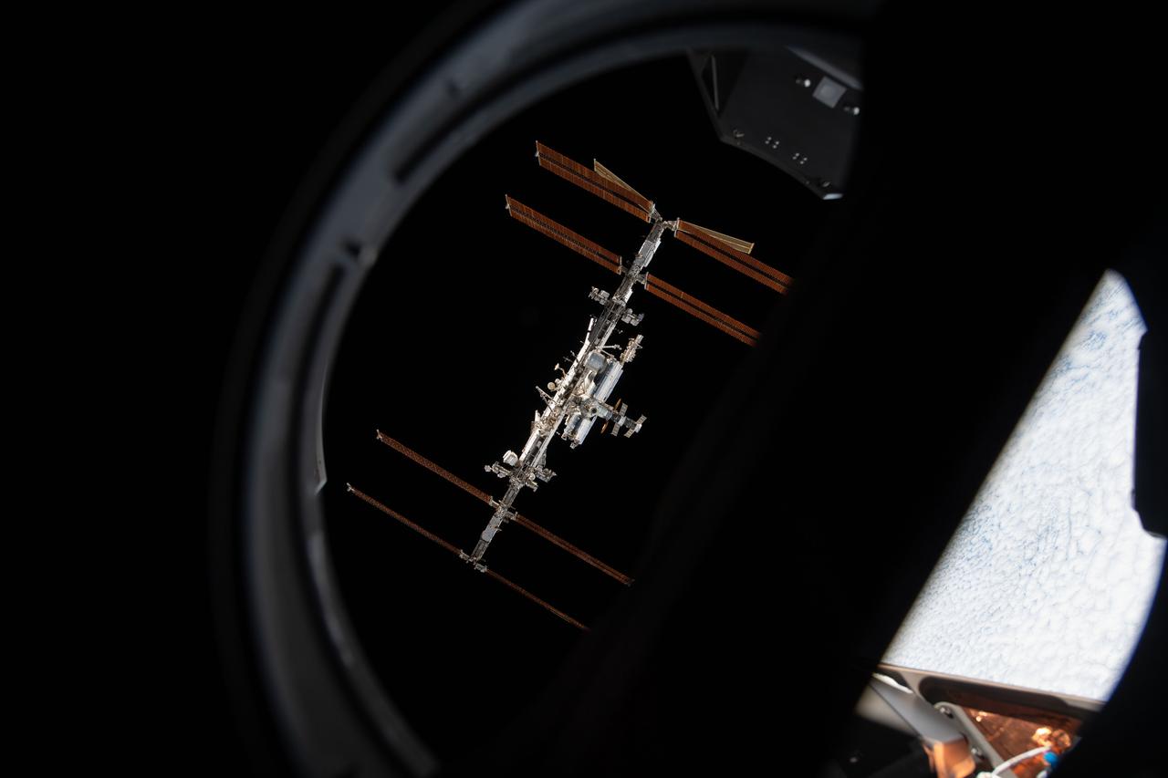 iss066e080912 (Nov. 8, 2021) --- The International Space Station is pictured from inside a window aboard the SpaceX Crew Dragon Endeavour during a fly around of the orbiting lab that took place following its undocking from the Harmony module’s space-facing port on Nov. 8, 2021.