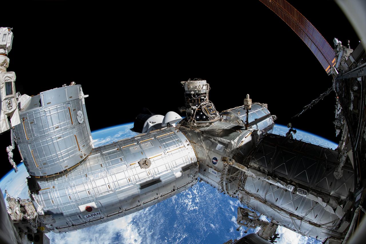 iss066e085978 (Dec. 2, 2021) --- A portion of the International Space Station's U.S. segment is pictured from NASA spacewalker Thomas Marshburn's camera. From left, are the Kibo laboratory module; the Harmony module, to which the SpaceX Crew Dragon Endurance is docked, and the space-facing international docking adapter; the Columbus laboratory module; and the U.S. Destiny laboratory module.
