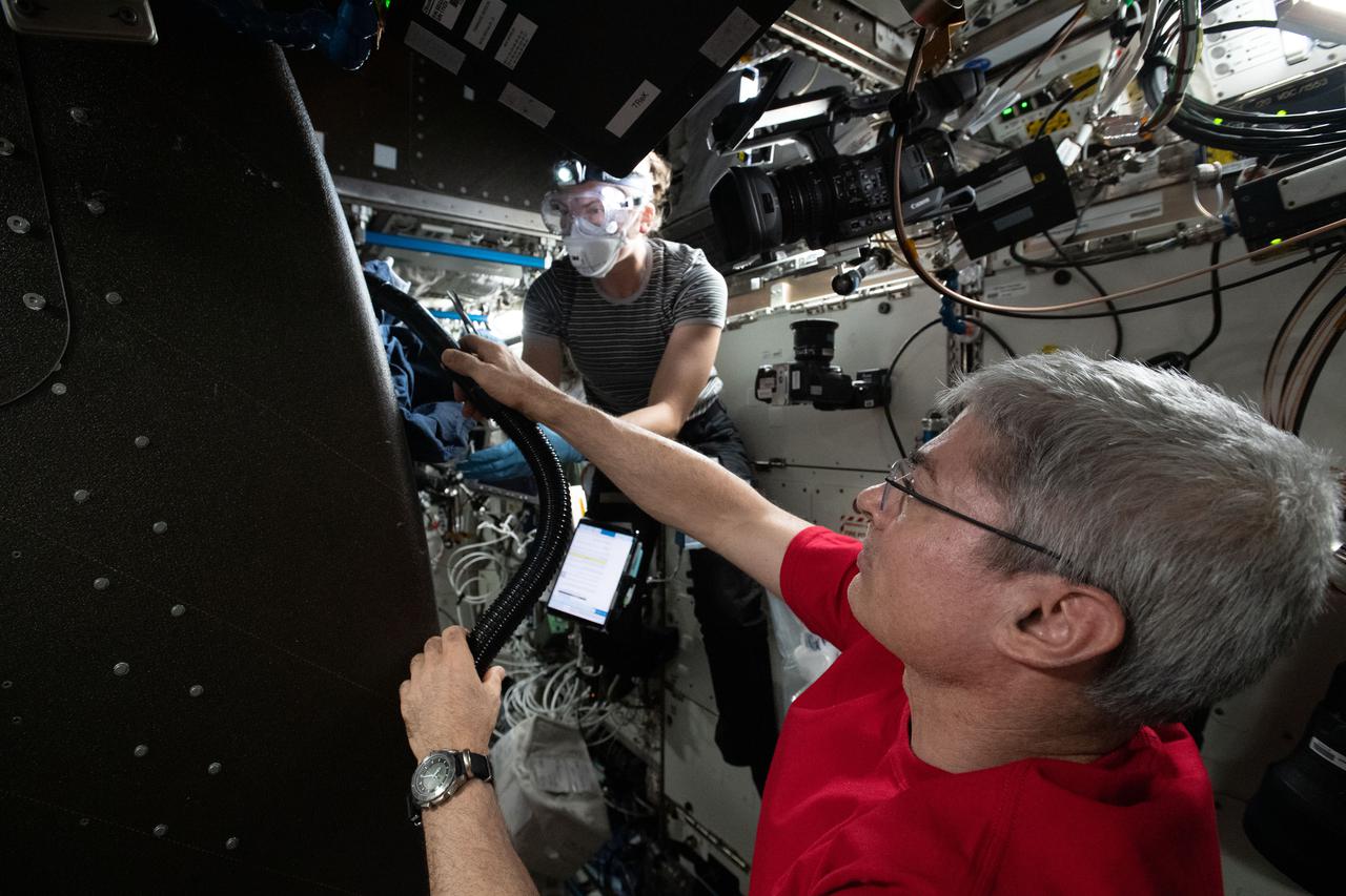 iss066e086431 (Dec. 4, 2021) --- NASA astronauts and Expedition 66 Flight Engineers Mark Vande Hei and Kayla Barron inspect cables inside the Materials Science Research Rack. The space physics device enables the observation of many material types, such as metals, alloys, polymers, semiconductors, ceramics, crystals, and glasses, to study and discover new applications for existing materials and new or improved materials.