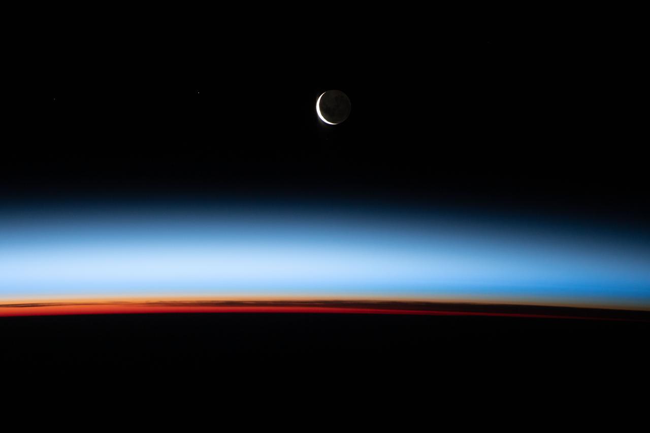 iss066e086969 (Dec. 6, 2021) --- A waxing crescent Moon during is pictured from the International Space Station during an orbital sunset as it flew 268 miles above the Pacific Ocean east of New Zealand.